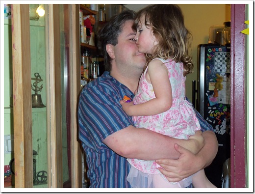 Chris giving Rosemary a cuddle in the kitchen doorway
