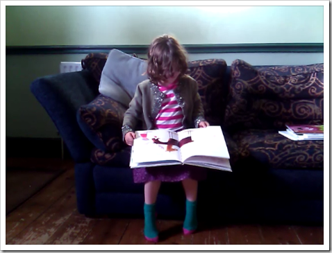 RoRo reading This Moose Belongs To Me by Oliver Jeffers